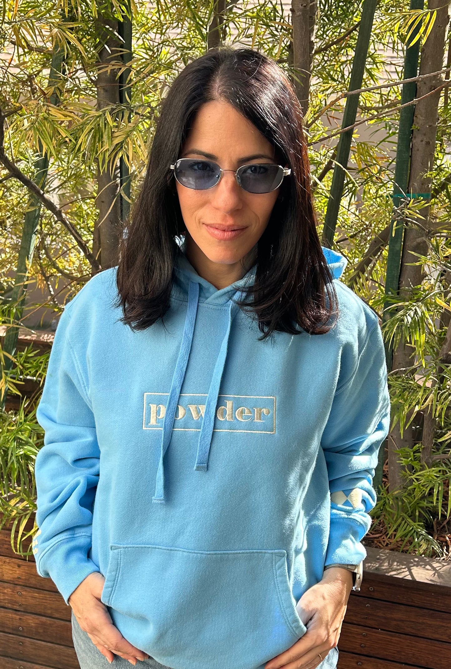 Model in Alaskan Blue Hoodie with sunglasses - resort style look