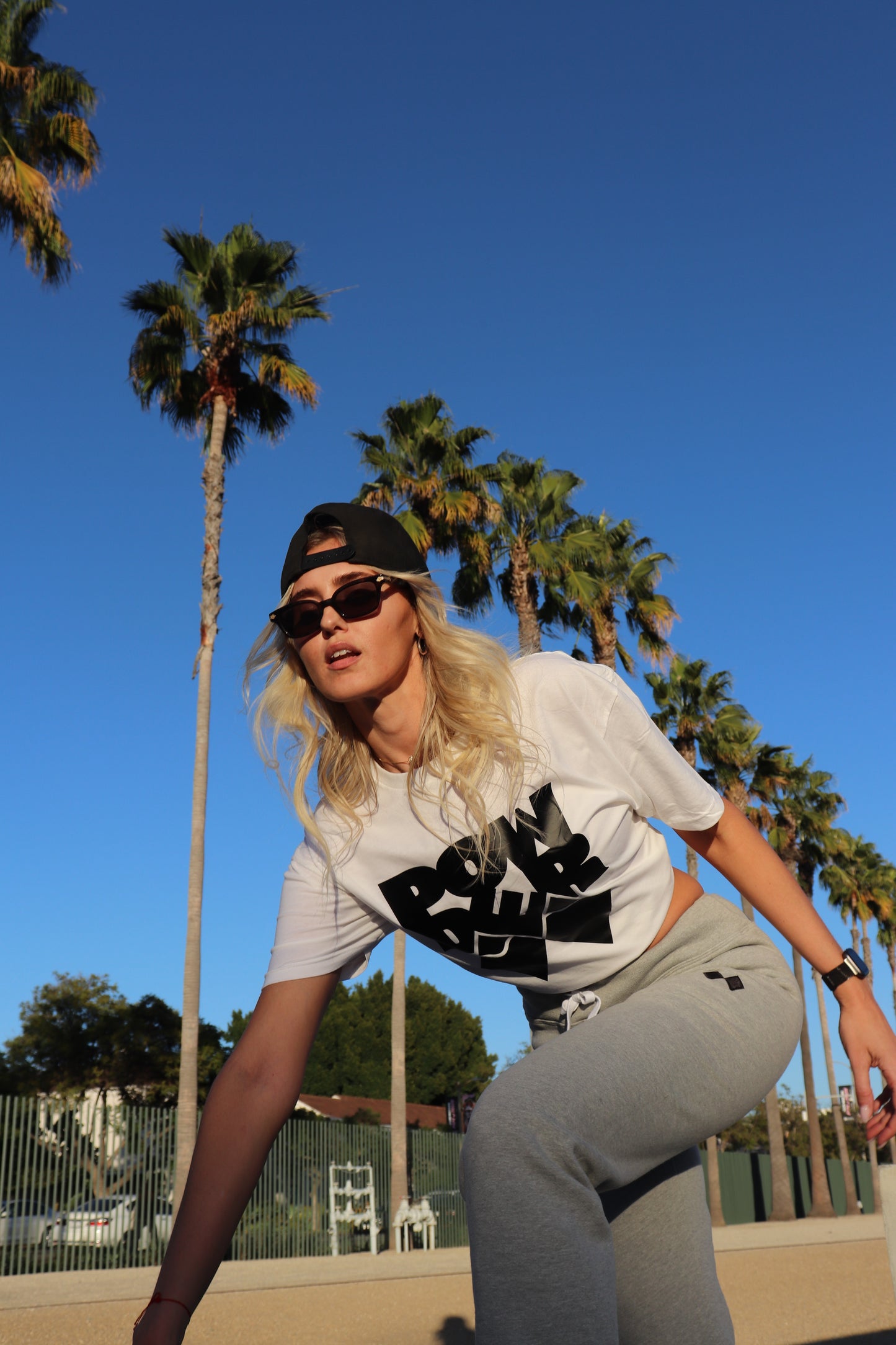 Model wearing Heather Grey PowderLA sweatpants by the beach
