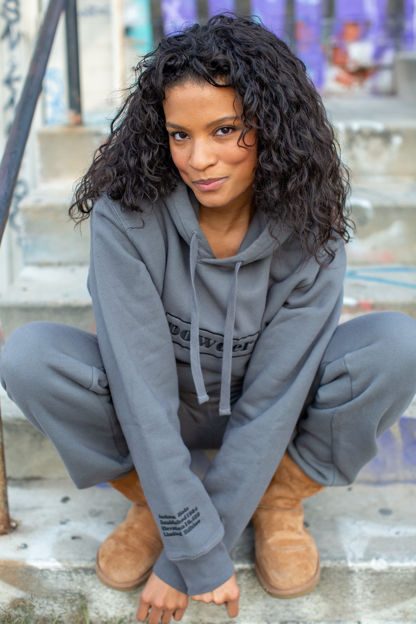 Model wearing oversized charcoal hoodie with Jackson Hole print
