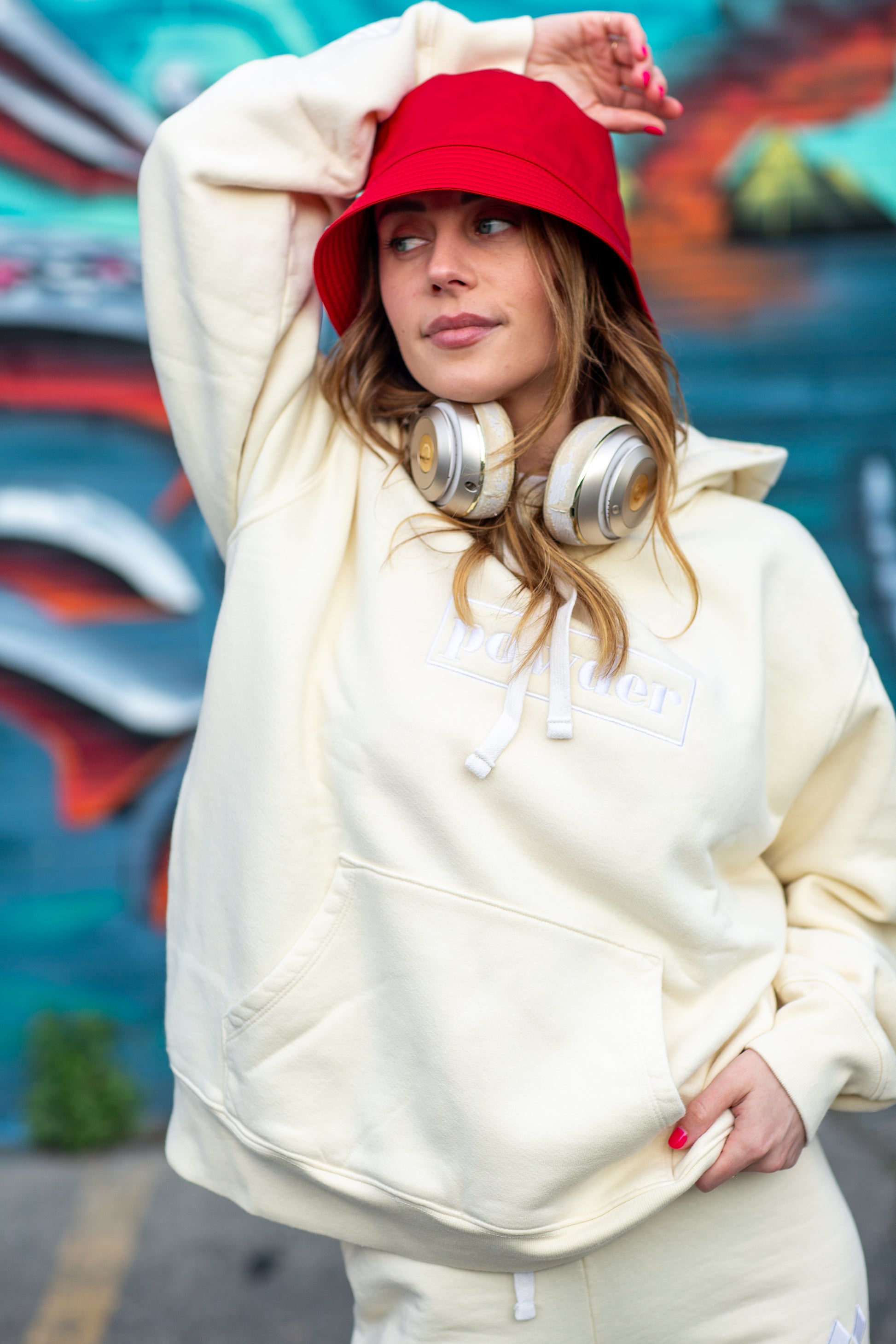 Close-up of cream monochrome hoodie in action - relaxed luxury streetwear vibe