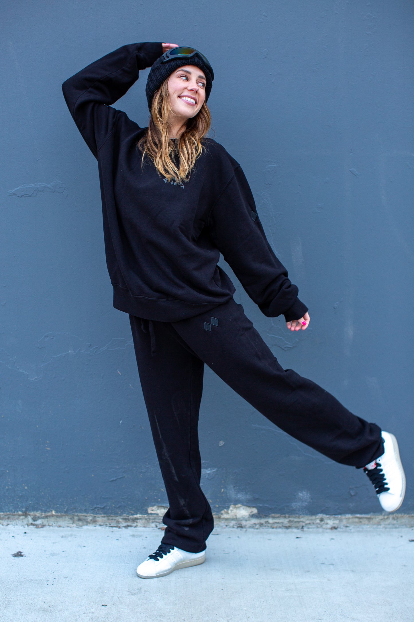 Model wearing Jet Black Sweatpants with matching crewneck