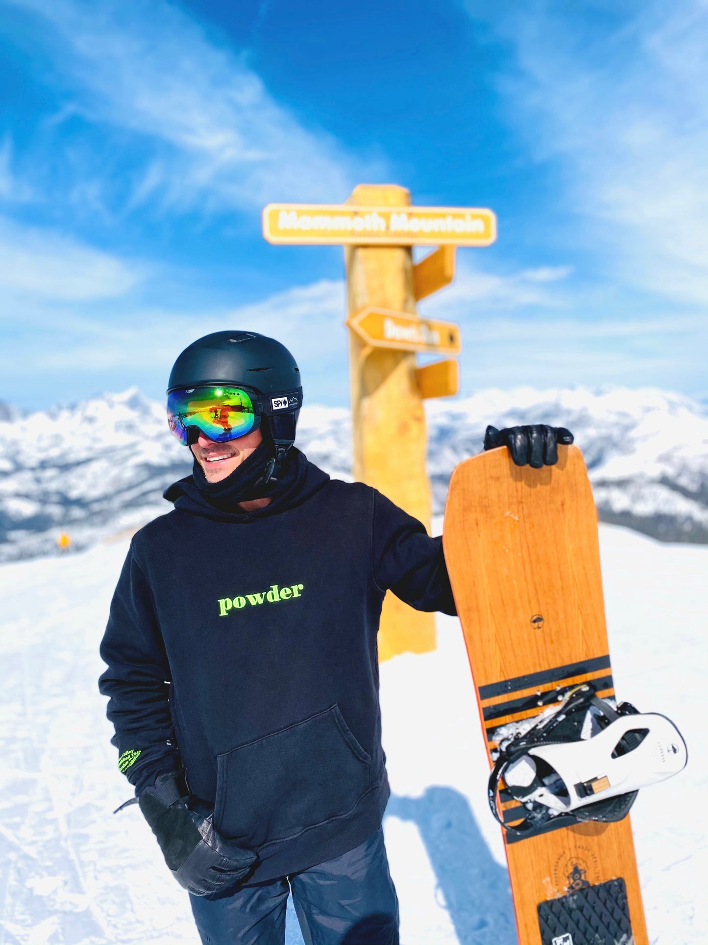 model in jet black & neon green hoodie holding snowboard - PowderLA