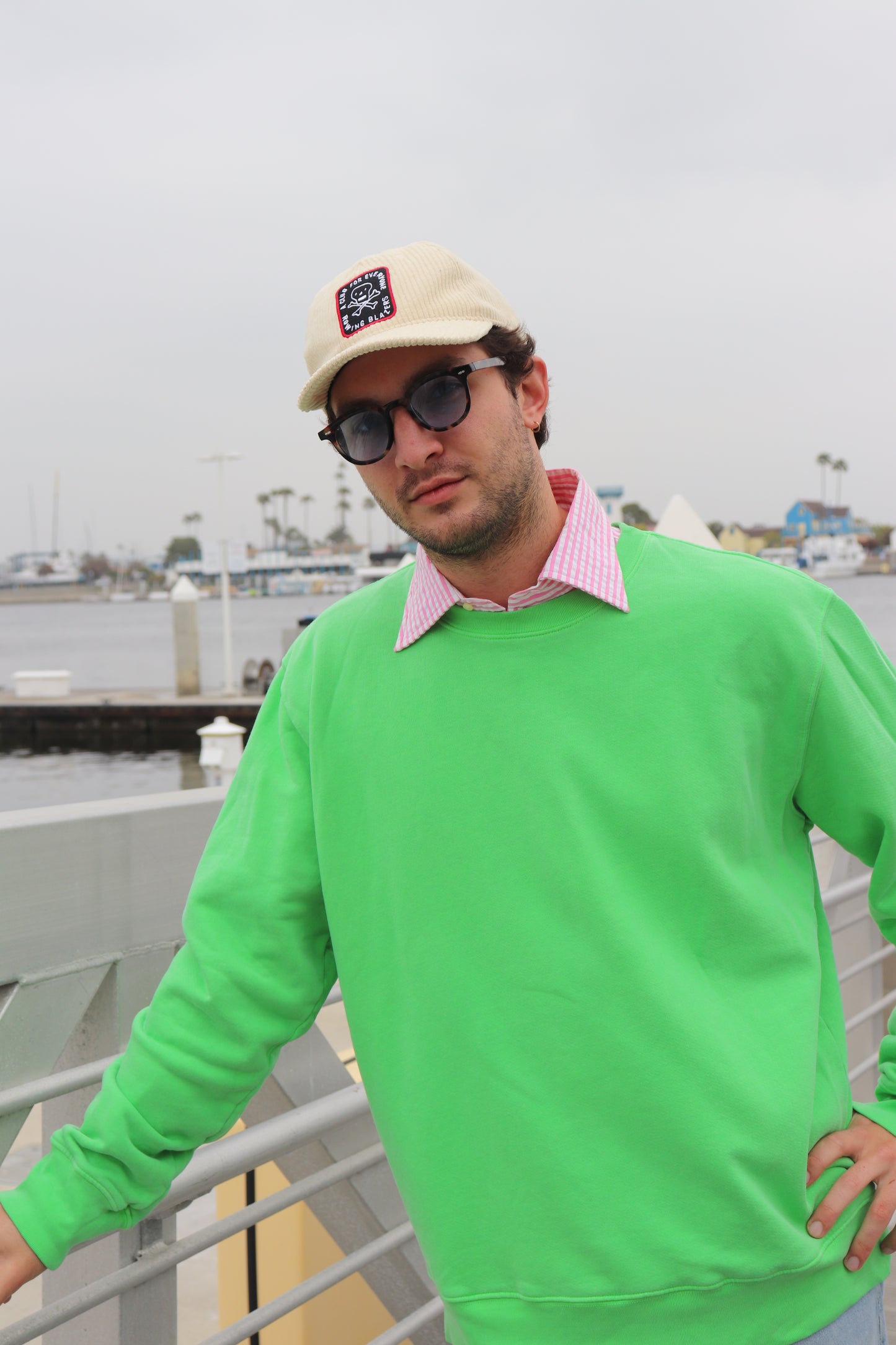 Model walking in Bowie Green sweatshirt near waterfront