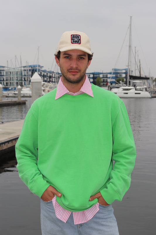 Model wearing Bowie Green crewneck at marina, front view